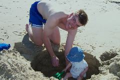 Daddy digging Maya a hole